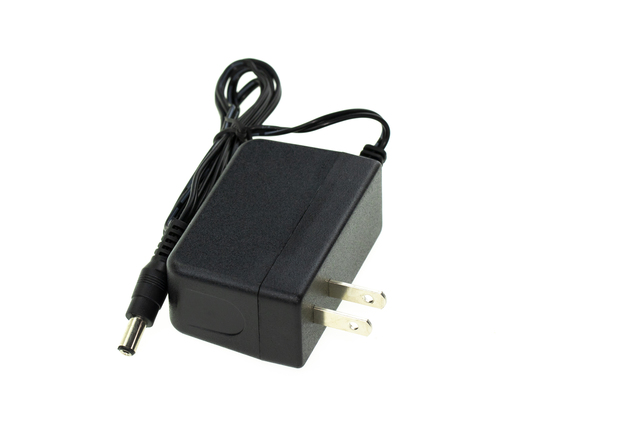 Image of Black Electric power adapter isolated on white backgrou